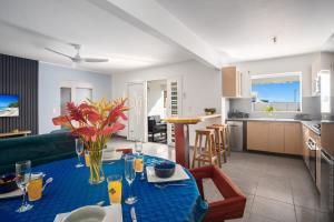 a living room and kitchen with a table with a blue table cloth at Villa 2 chambres, Jacuzzi et Piscine in Maximin