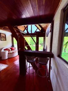 a room with a table and chairs in a room at Chalé Sertão da Boa Vista in Rio Claro