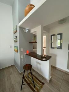 a kitchen with a counter and a stool in a room at Casa laberinto, Entre cerros, cómoda cama de 2x2 in Salta