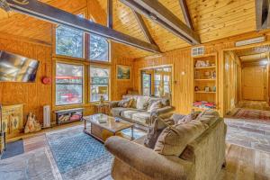 a living room with two couches and a fireplace at Peaceful & Private Cloudcroft Cabin with Deck! in Cloudcroft