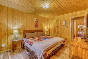 a bedroom with a bed and a wooden ceiling at Peaceful & Private Cloudcroft Cabin with Deck! in Cloudcroft