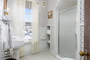 a white bathroom with a sink and a shower at The Berkshire Mountain Inn in Great Barrington +59 photos