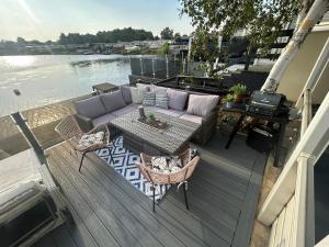 a patio with a couch and chairs and a table at sunset luxury lakeside lodge with hot-tub,3 bedrooms, pet friendly in Tattershall +51 photos