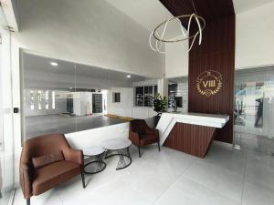 a kitchen with two chairs and a table and a counter at América Colares VII in Los Frailes