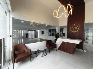 a kitchen with two chairs and a table and a bar at América Colares VII in Los Frailes