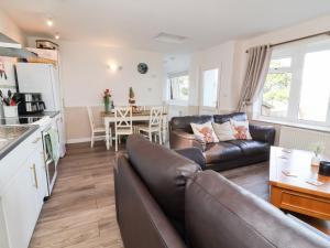 a living room with a couch and a table at Castle View Lodge in Ilfracombe