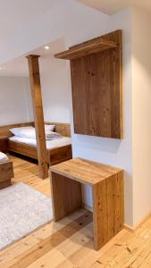 a room with two bunk beds and a wooden bench at Vogelbauer Apartments in Egling +16 photos