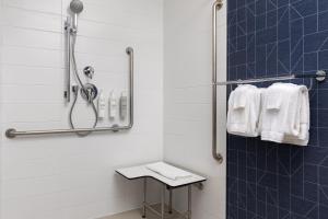 a bathroom with a shower with white towels at Spark By Hilton Woodstock in Woodstock +22 photos