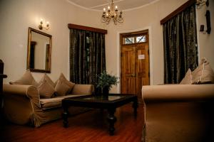 a living room with a couch and a table at Hotel Mount Pleasant in Bandarawela