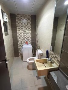 a bathroom with a toilet and a sink at Olive Residence Madinah in Medina +22 photos