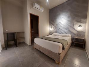a bedroom with a large bed and a desk at Hotel Kyros by 70 in Medellín +11 photos