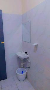 a white bathroom with a sink and a toilet at The Great Stay Mtwapa in Mtwapa +8 photos