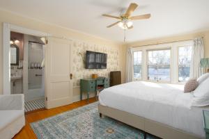 a bedroom with a bed and a ceiling fan at The Berkshire Mountain Inn in Great Barrington