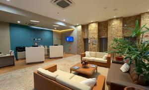 a lobby with couches and a table and a counter at Natal Plaza Hotel in Natal