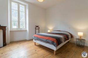 a bedroom with a bed and two lamps in it at Maison de Marius et Maison d Amelie in Esténos