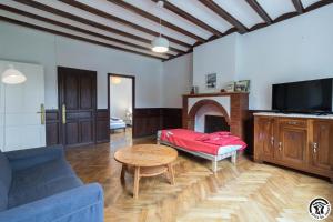 a living room with a couch and a table at Maison de Marius et Maison d Amelie in Esténos
