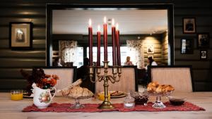 a table with candles and food on a table at Sov Lodge in Vågåmo