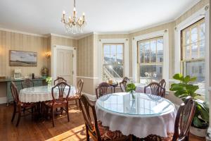 a dining room with a table and chairs at The Berkshire Mountain Inn in Great Barrington
