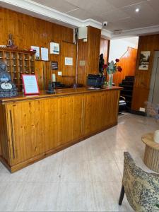 a wooden counter in a room with a person standing behind it at Hotel Mesón el 21 in Almería