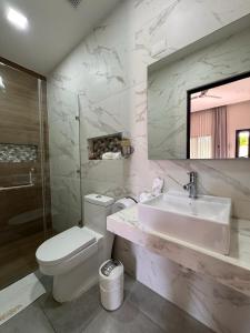 a bathroom with a sink and a toilet and a mirror at Hotel Margarita in Flores +29 photos