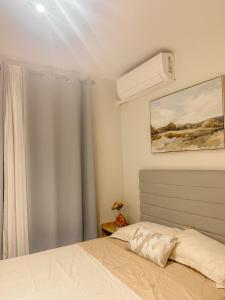 a bedroom with a bed and a air conditioner at Condo at 16th Floor Free Pool Access with Private Balcony in Suba +19 photos