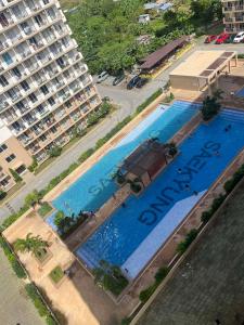 an overhead view of a large swimming pool next to a building at Condo at 16th Floor Free Pool Access with Private Balcony in Suba