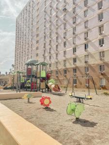a playground in front of a large building at Condo at 16th Floor Free Pool Access with Private Balcony in Suba