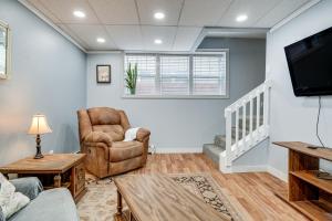 a living room with a tv and a couch and chair at Downtown Casper Gem! Super Walkable Apartment in Casper