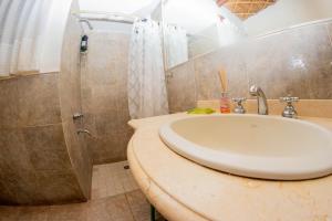 a bathroom with a sink and a shower at Tilcara Casa con 3 dorm Pedacito de Cielo in Tilcara +39 photos