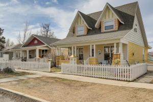 a house with a white fence in front of it at Downtown Casper Gem! Super Walkable Apartment in Casper