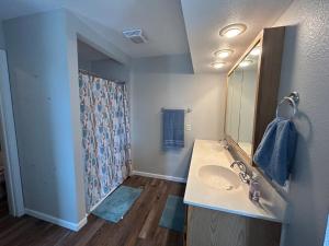 a bathroom with a sink and a mirror at The Palace in Mandan