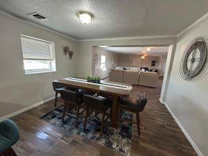 a dining room with a table and chairs and a living room at The Palace in Mandan +16 photos