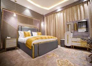 a bedroom with a large bed and a mirror at Lambert ApartHotel in Jeddah