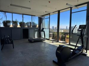an office with a gym with a view of the city at Luxury apartment near Andares in Guadalajara