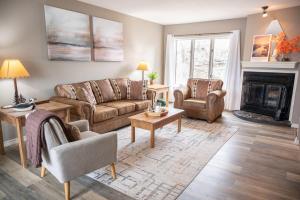 a living room with two couches and a fireplace at Lakescape at the Getaways in Kimberling City