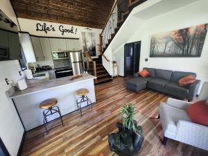 an open living room with a kitchen and a living room at Life's Good Retreat Bear Cottage in Brevard
