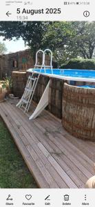 a ladder sitting on a deck next to a swimming pool at Piccola Sorpresa Il preferito degli escursionisti sul Cammino in Scoppieto