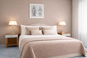 a bedroom with a large bed with two night stands at Appartamento Corso Italia 269 in Sorrento