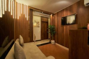 a living room with a couch and a tv at Giza Pyramids& GYM View in Cairo