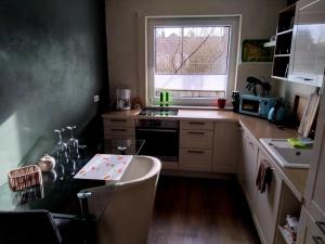 a small kitchen with a sink and a stove at Südharzperle in Bad Lauterberg