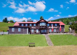 a large house with a bench in front of it at Chata Lion in Pec pod Sněžkou