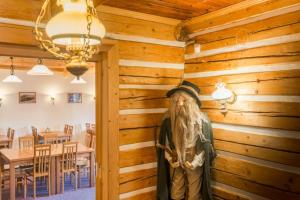 a statue of a fish in the corner of a dining room at Chata Lion in Pec pod Sněžkou