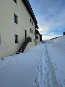 a building in the snow with footprints in it at Studio on the ski slopes in Passo del Tonale