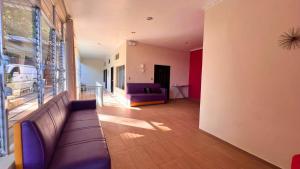 a living room with a couch and a window at Quinta Sunset, Lago de Coatepeque in El Congo