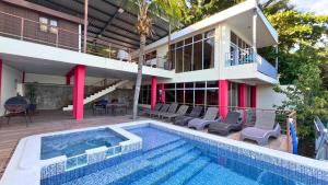 a villa with a swimming pool and a house at Quinta Sunset, Lago de Coatepeque in El Congo
