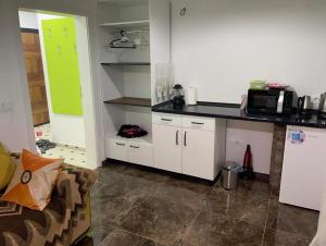 a kitchen with white cabinets and a counter top at River Side Apartment in Prizren