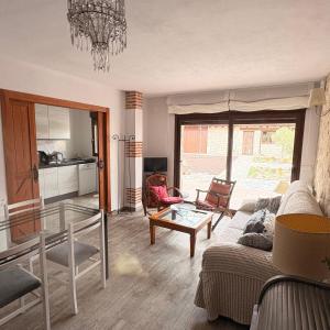 a living room with a couch and a table at El Jardín de los Olivos in Fuentesaúco de Fuentidueña