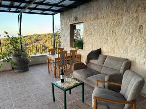 a living room with a couch and a table at בשקט שלך in Mattat