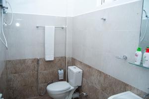 a bathroom with a toilet and a shower at Rainforest Jungle Chill Singharaja in Deniyaya