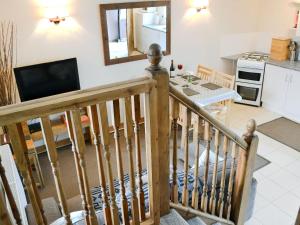a staircase leading to the kitchen and living room of a holiday home at Keepers in Marros
